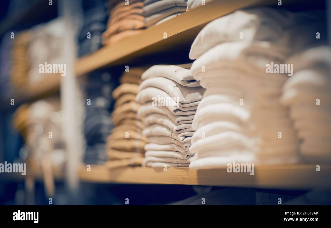 Stacks of clothes. Shopping in store. Clothing on the shelves in shop ...