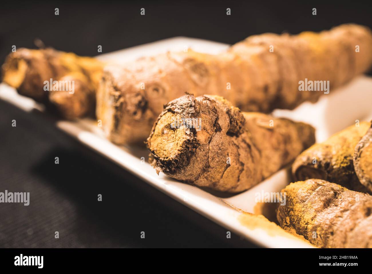 Ginger Roots on a dark background Stock Photo