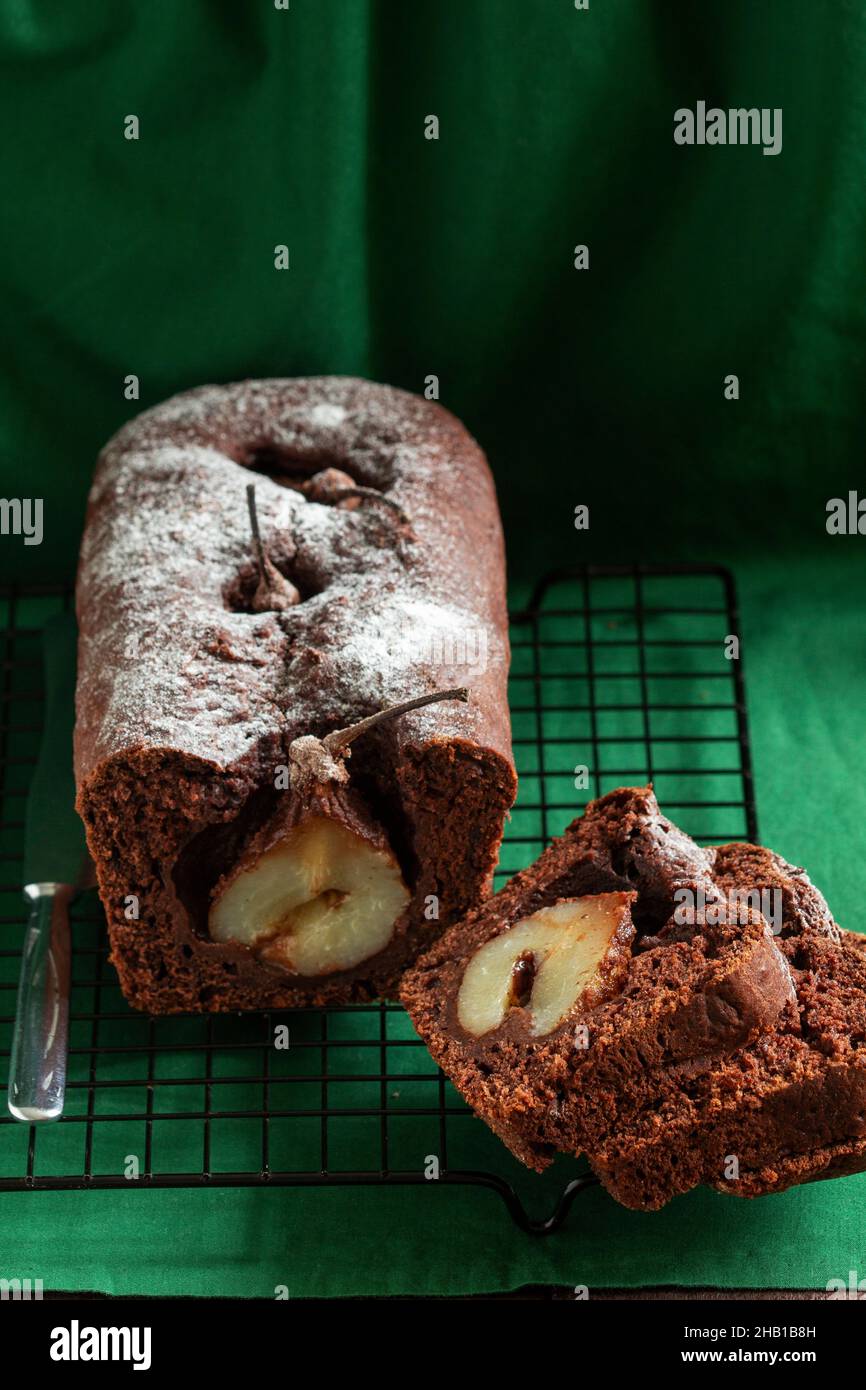 Chocolate pear cake on a green background. Rustic style. Stock Photo