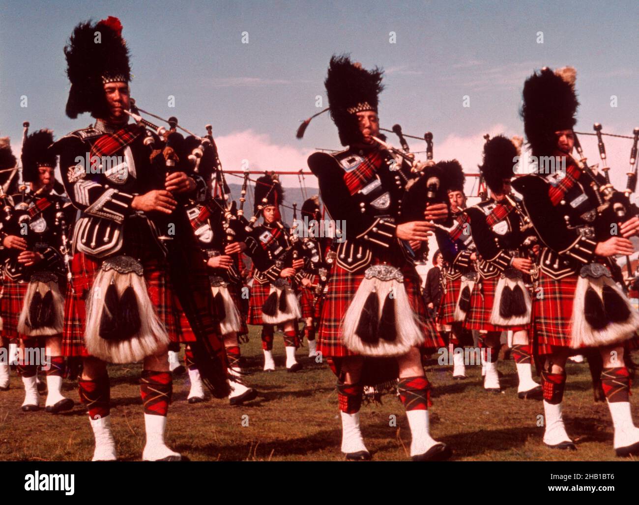 Marching band pipers playing bagpipes Scottish Highland games, Aboyne,  Scotland, UK c 1960s Stock Photo