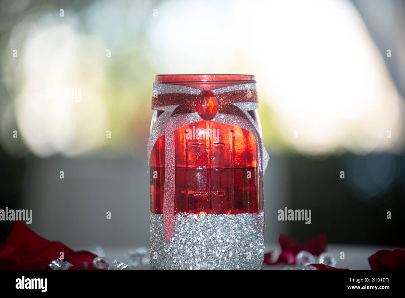 Red candle holder with silver glitter bottom and red gem stone Stock