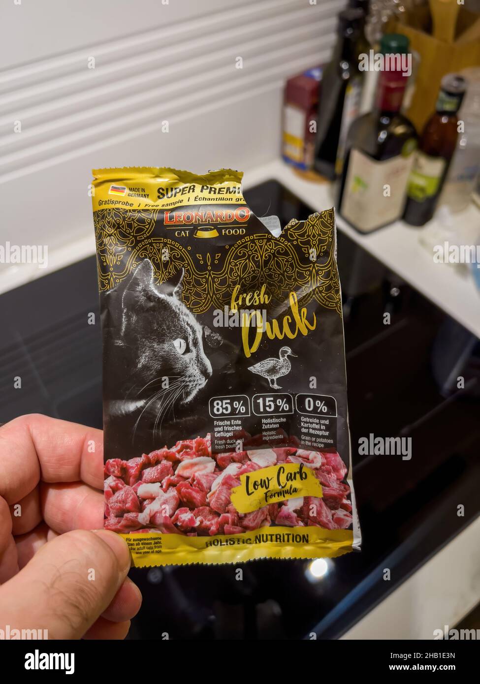 Male hand holding sample cat food manufactured by Leonardo Stock Photo Alamy