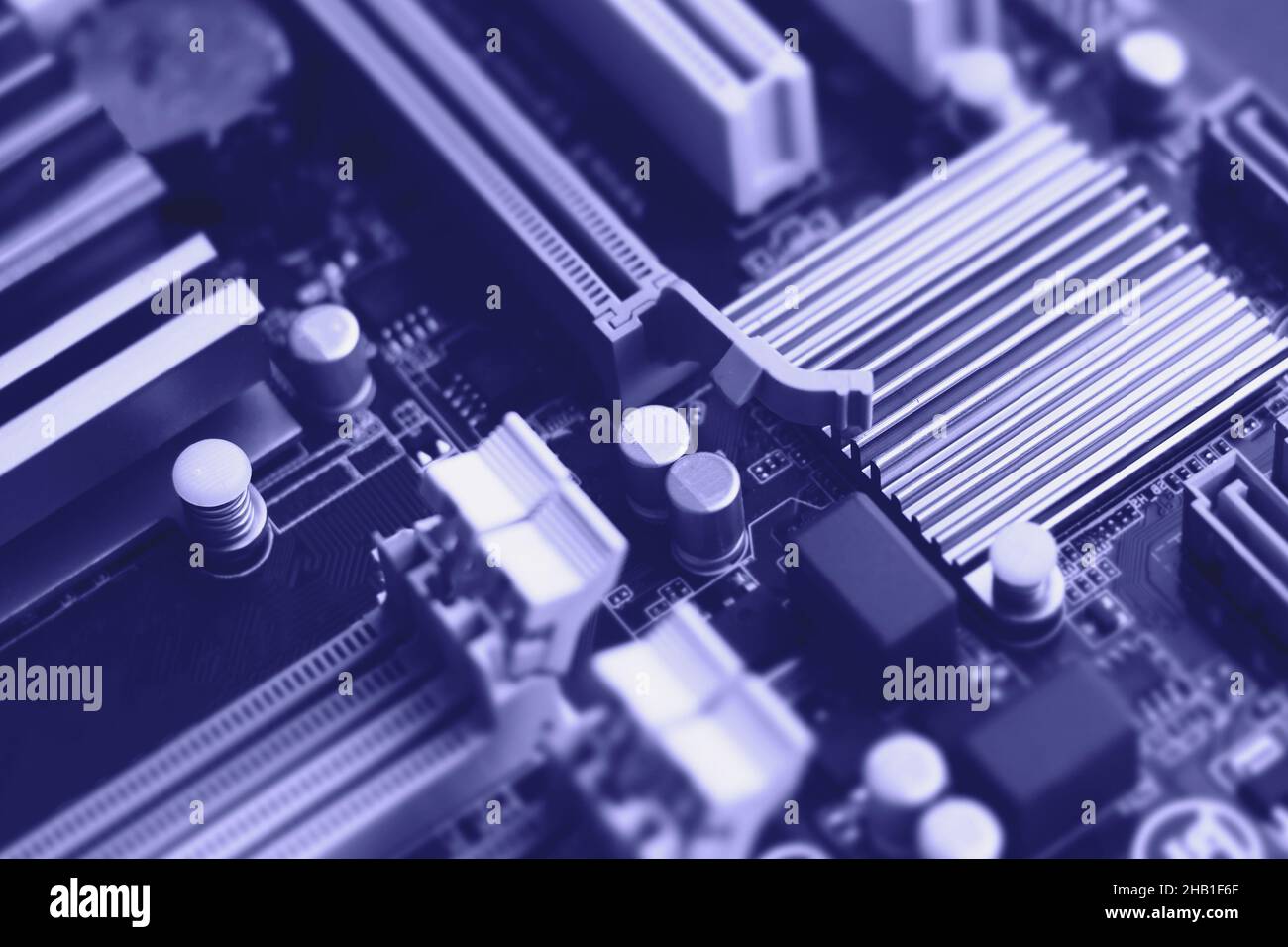Defocused trendy very peri color concept of the year 2022, violet blue, lavender computer motherboard closeup background. Selective focus Stock Photo