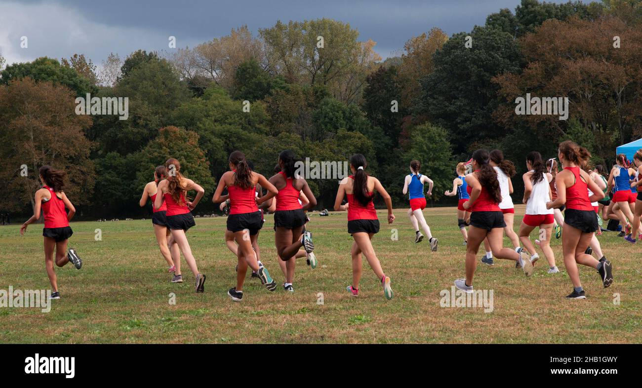 Rear view of the start of a high school girls 5K cross country race in