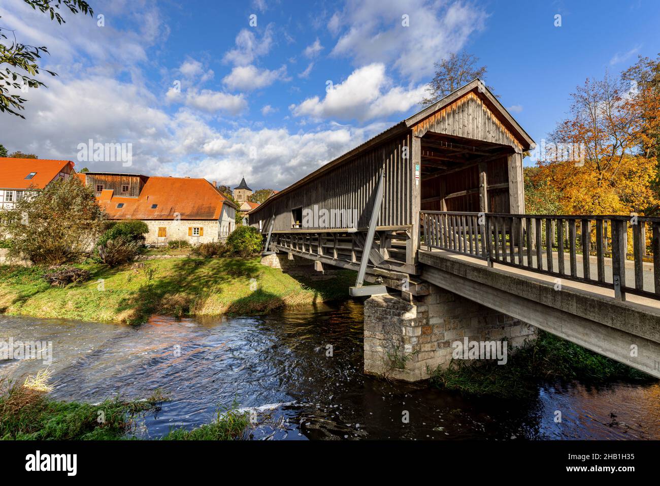 Roofed wooden bridge over the river Ilm in Buchfart, Thuringia, Germany. Stock Photo