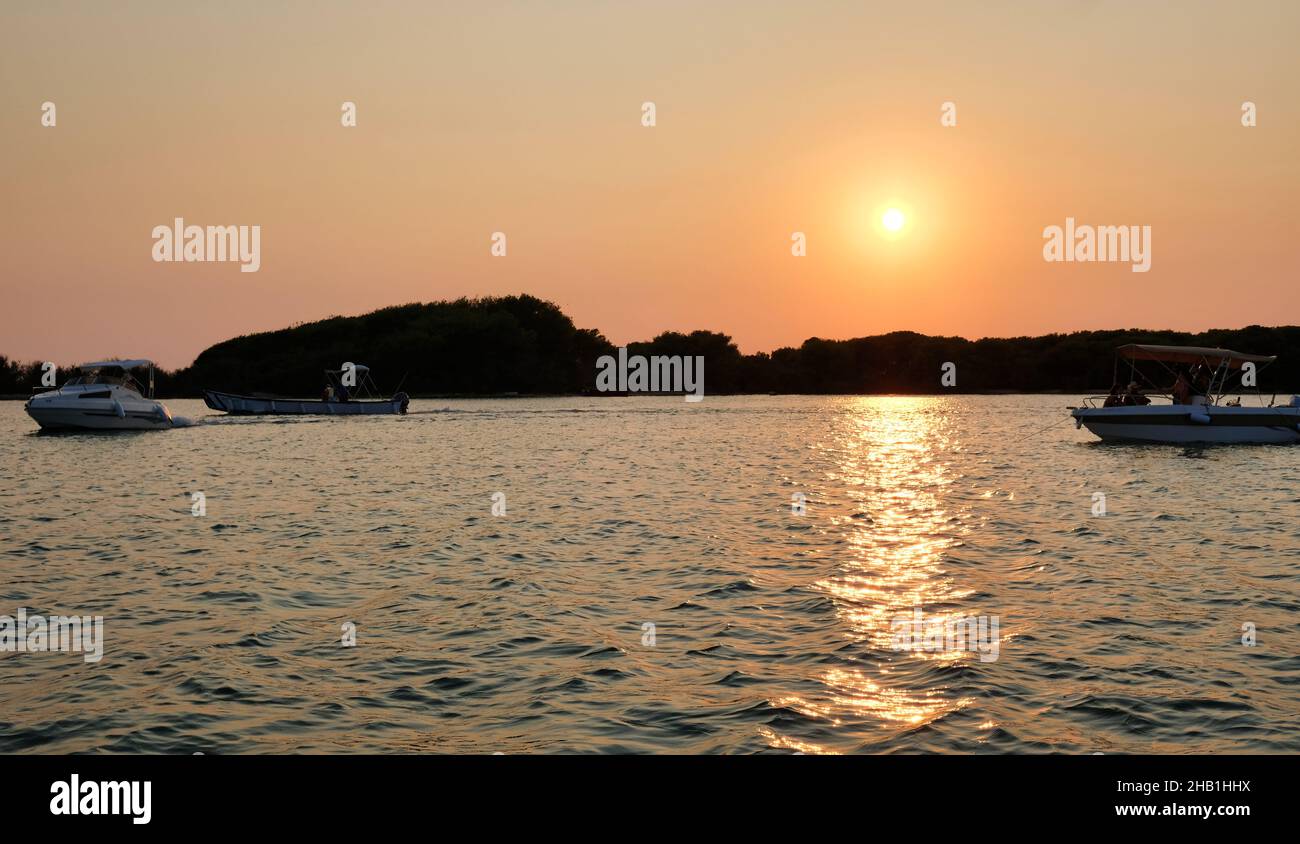 Salento coast: view at sunset of Porto Cesareo in Apulia, Italy. In the background the Island of the Rabbits Stock Photo