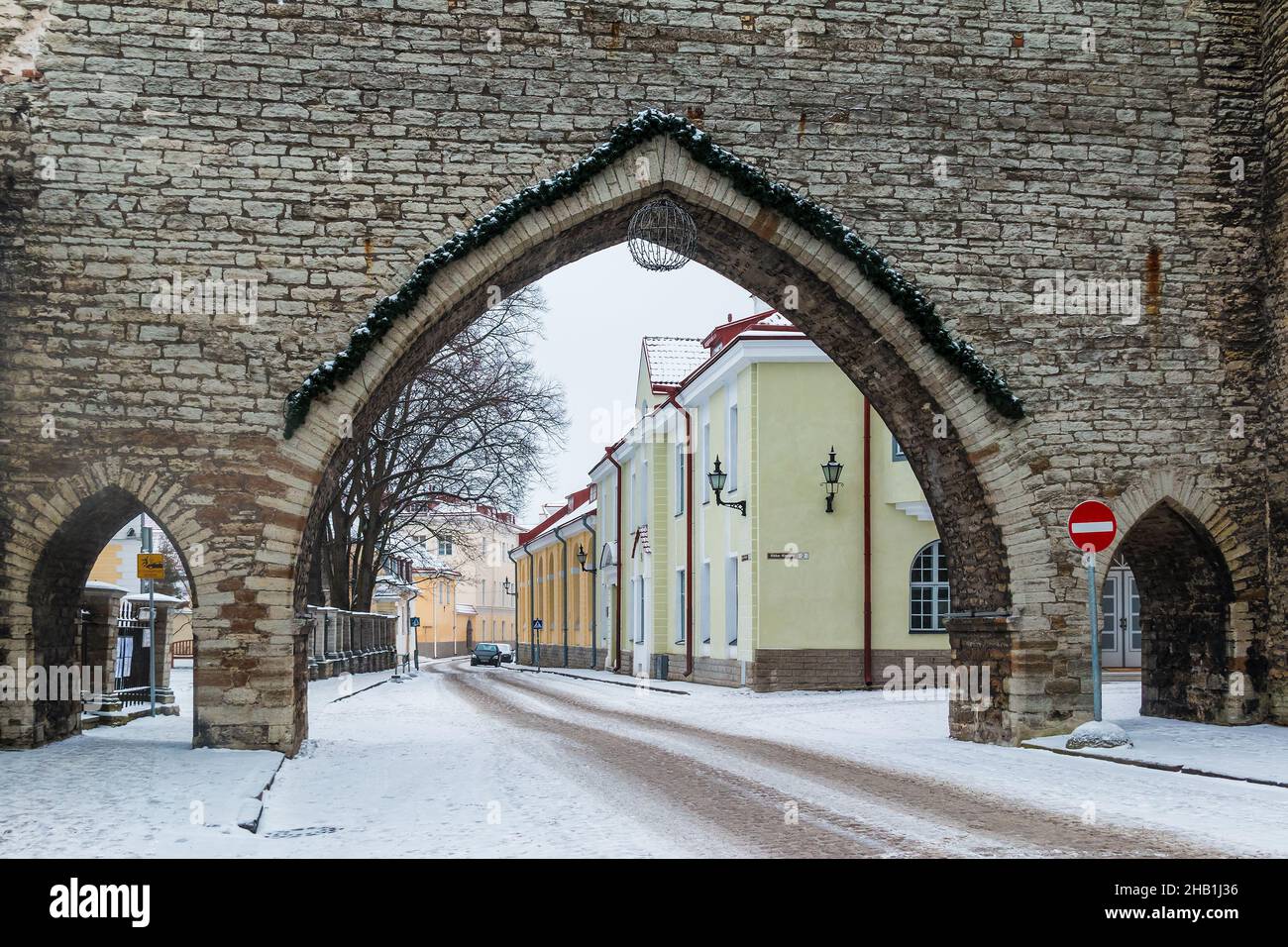 The Monastery Gate and perspective view of the Suur-Kloostri Street in the Tallinn Old Town in overcast winter day Stock Photo