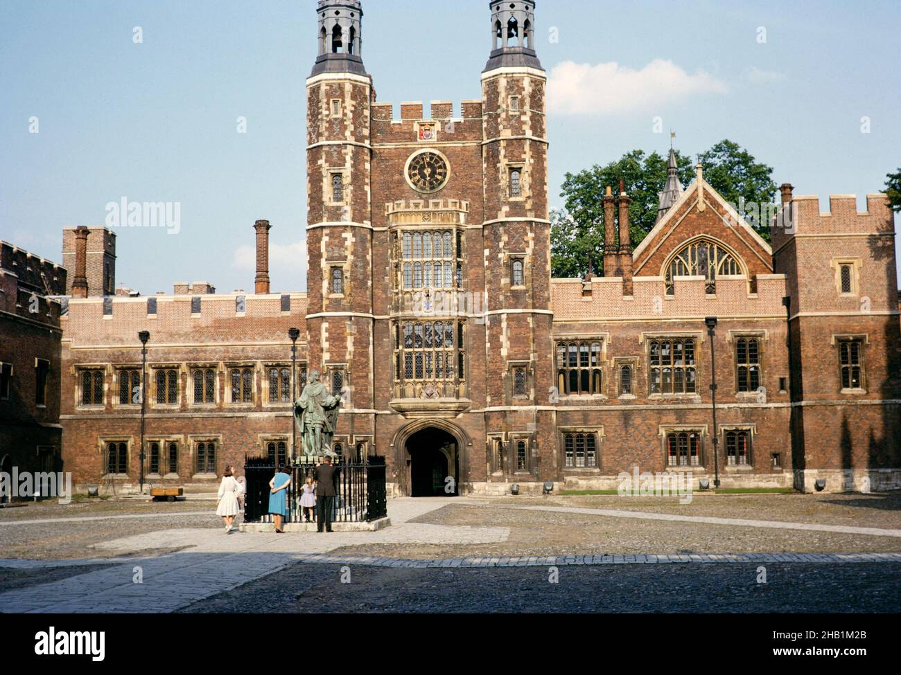 People by statue of founder King Henry VI, in School Yard courtyard, Eton College, Windsor, Berkshire, England 1963 Stock Photo