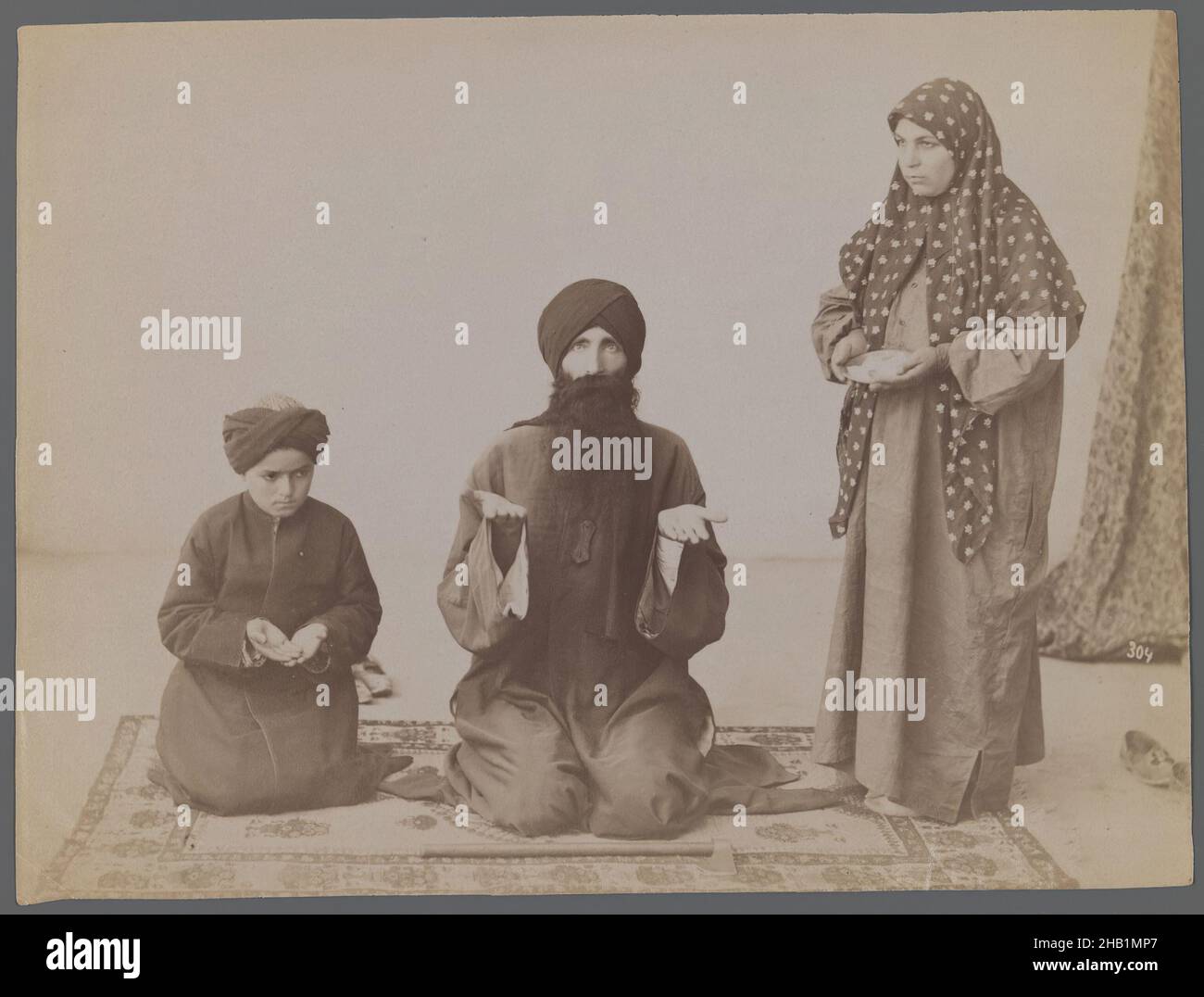 One of 274 Vintage Photographs, Albumen silver photograph, late 19th-early 20th century, Qajar, Qajar Period, 6 1/8 x 8 3/16 in., 15.6 x 20.8 cm, beard, family, father, hijab, Islam, Middle East, mother, Persia, prayer, rug, son Stock Photo