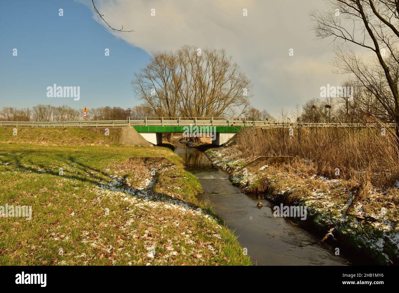 Small Bridge Spring A bridge that connects the two banks over a small stream on a cool ...