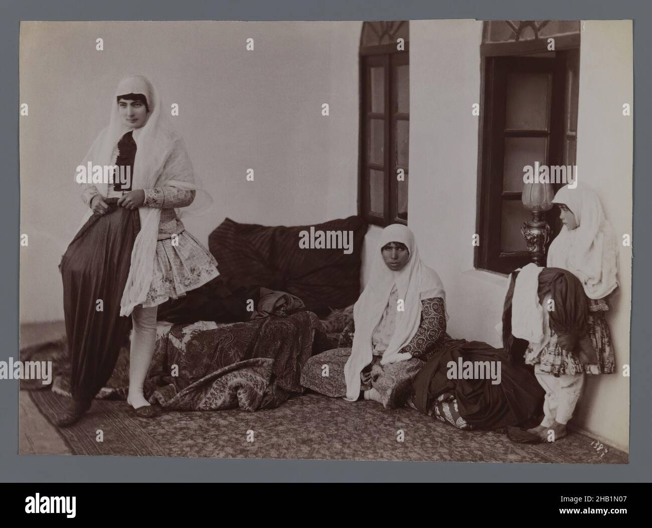 One of 274 Vintage Photographs, Albumen silver photograph, late 19th-early 20th century, Qajar, Qajar Period, 5 7/8 x 8 3/16 in., 14.9 x 20.8 cm, child, family, harem, hijab, historical fashion, Iran, mother, Persia, persian rug Stock Photo