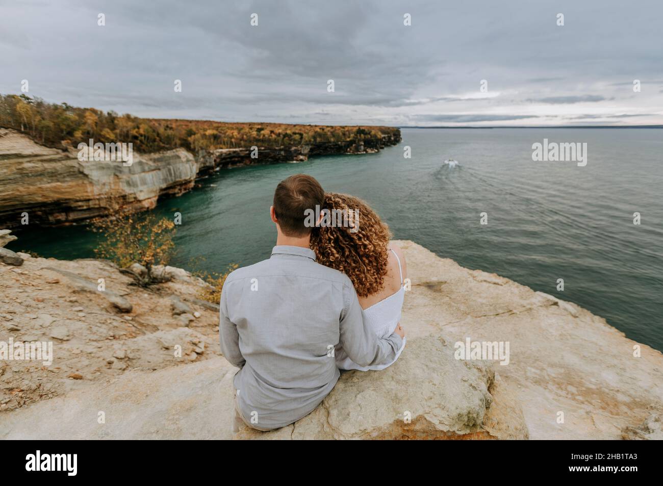 Couple hold each other looking over Lake Superior, Michigan Stock Photo