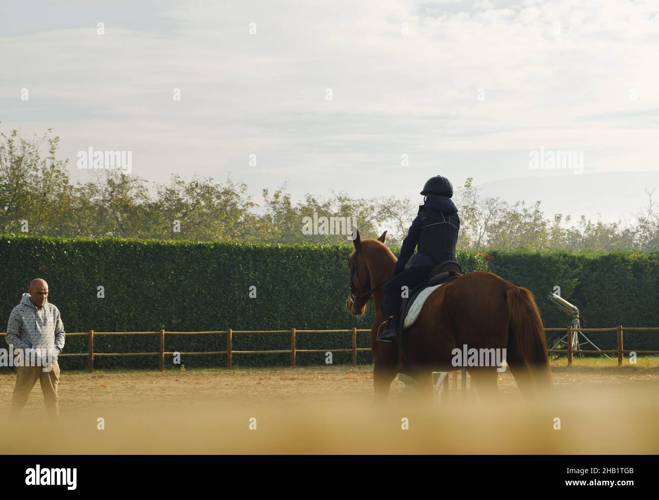 Kid learning horse back riding with teacher Stock Photo Alamy