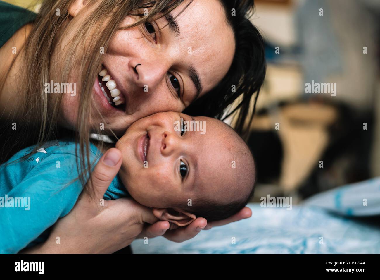 Portrait of a young woman smiling with her baby. Stock Photo