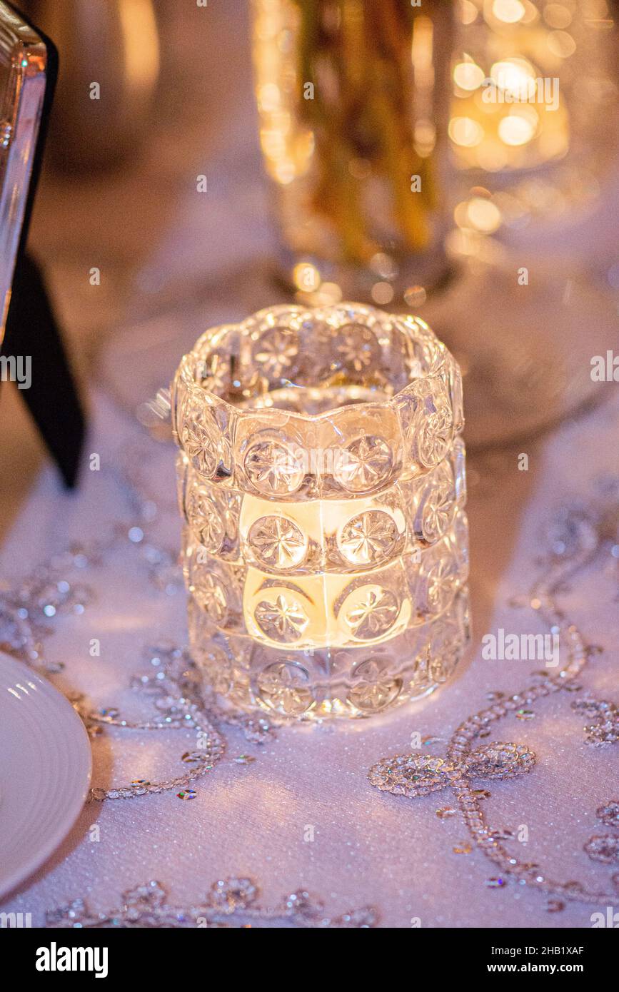 Gold decorative glass candle stick holder centerpiece on table at