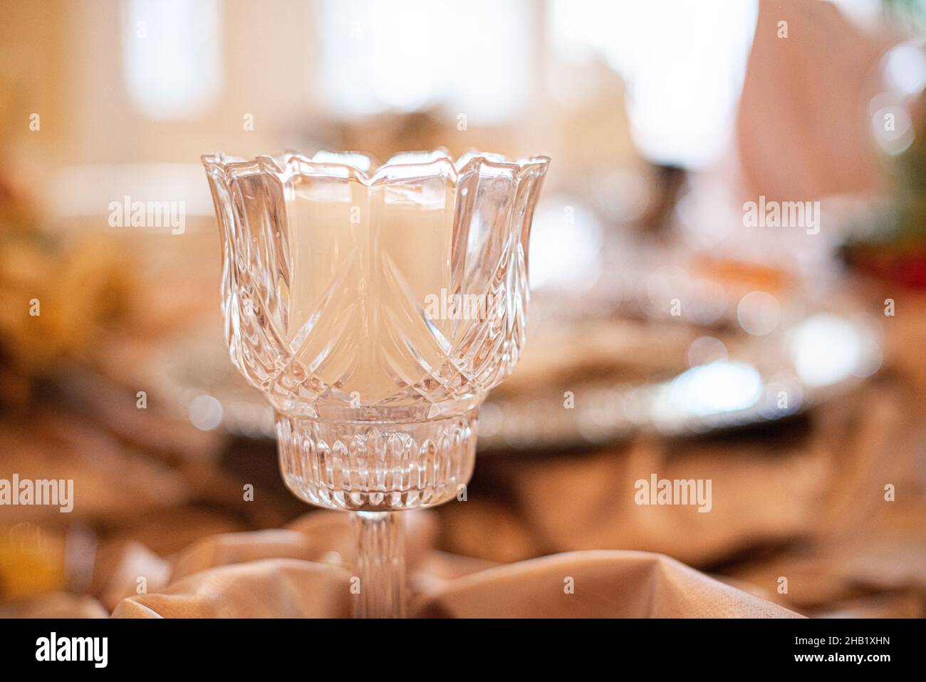 Glass decorative candle stick holder centerpiece on table at wedding