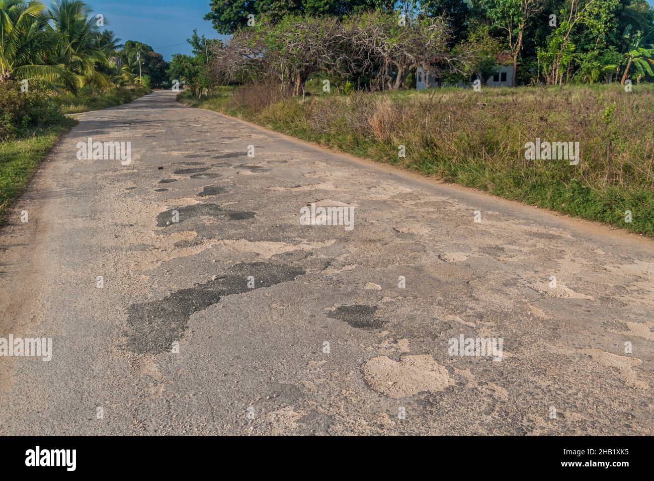 Potholed country road on Siquijor island, Philippines. Stock Photo