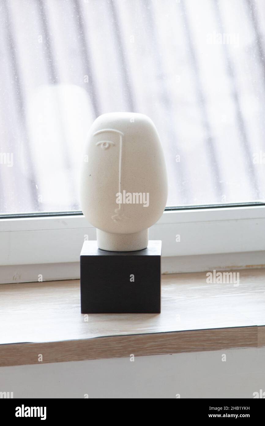 Plaster statue on wooden table Stock Photo
