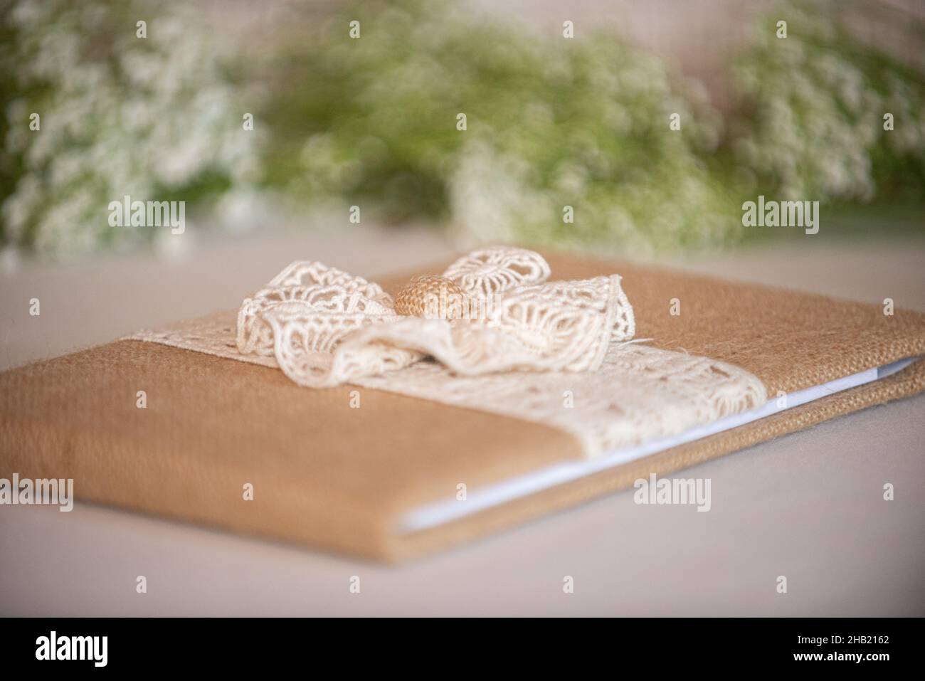 Burlap and lace with bow guest sign in book at wedding reception Stock Photo