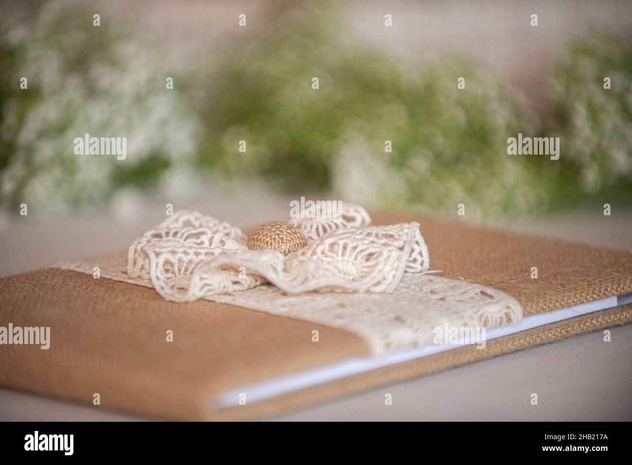 Burlap and lace with bow guest sign in book at wedding reception Stock Photo