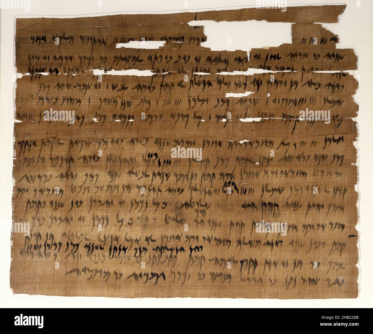 Marriage Document, Aramaic, Papyrus, ink, mud, linen, July 3, 449 B.C.E., Dynasty 27, Persian Period, Glass: 13 1/4 x 14 15/16 in., 33.7 x 38 cm, Aramaic, archaeology, b.c.e., contract, document, Elephantine, family, fragile, History, ink, Jewish, Jewish history, Jewish life, marriage, marriage document, marriage license, paper, papyrus, Persian Period, record, script, text, texts, torn, wedding, writing Stock Photo