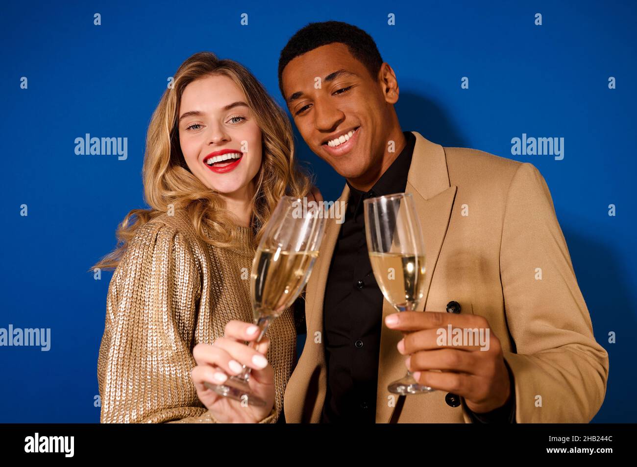 Smiling girl and guy holding glasses of champagne Stock Photo