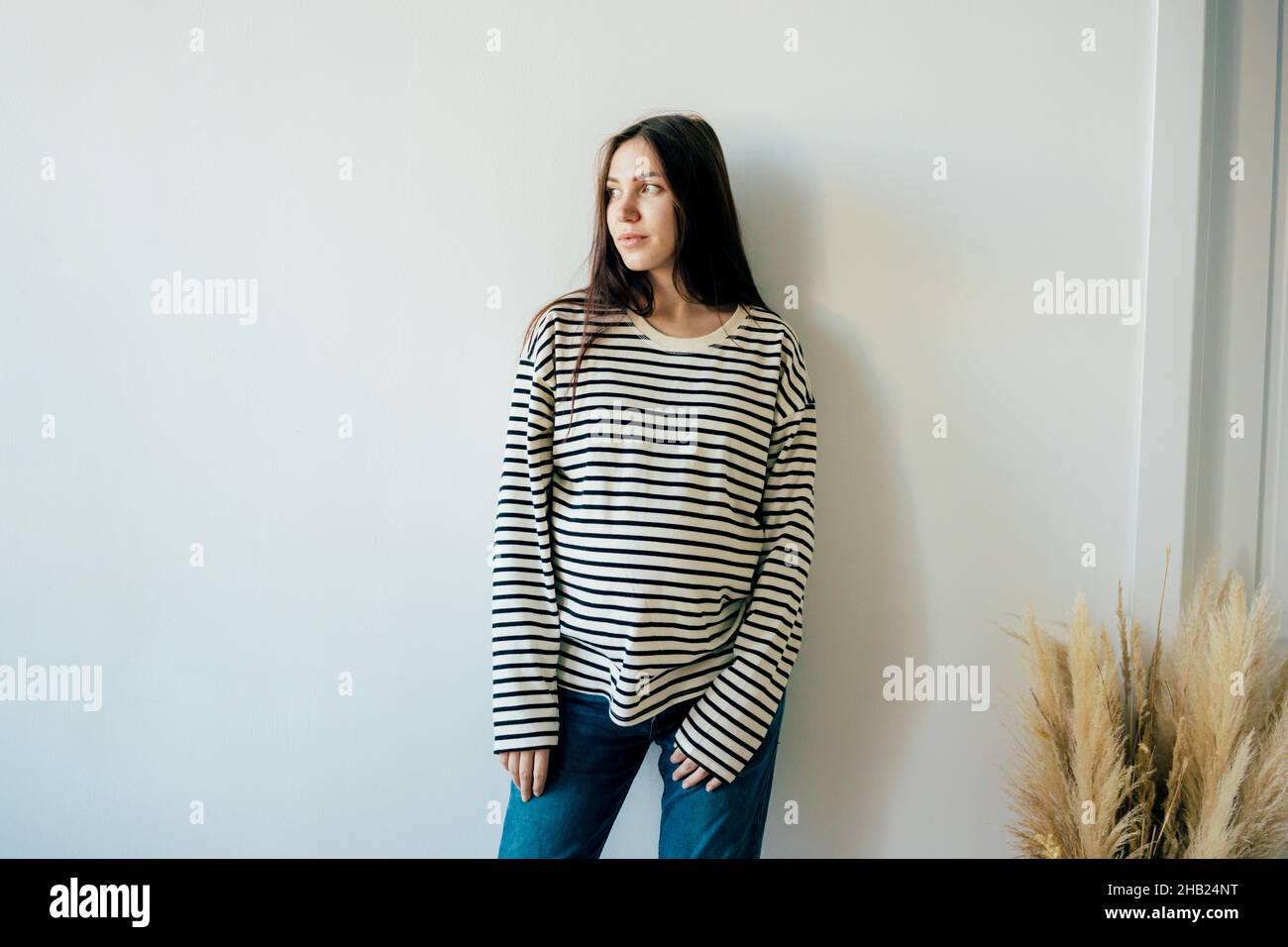 Portrait of a young stylish pregnant woman in casual clothes. Stock Photo