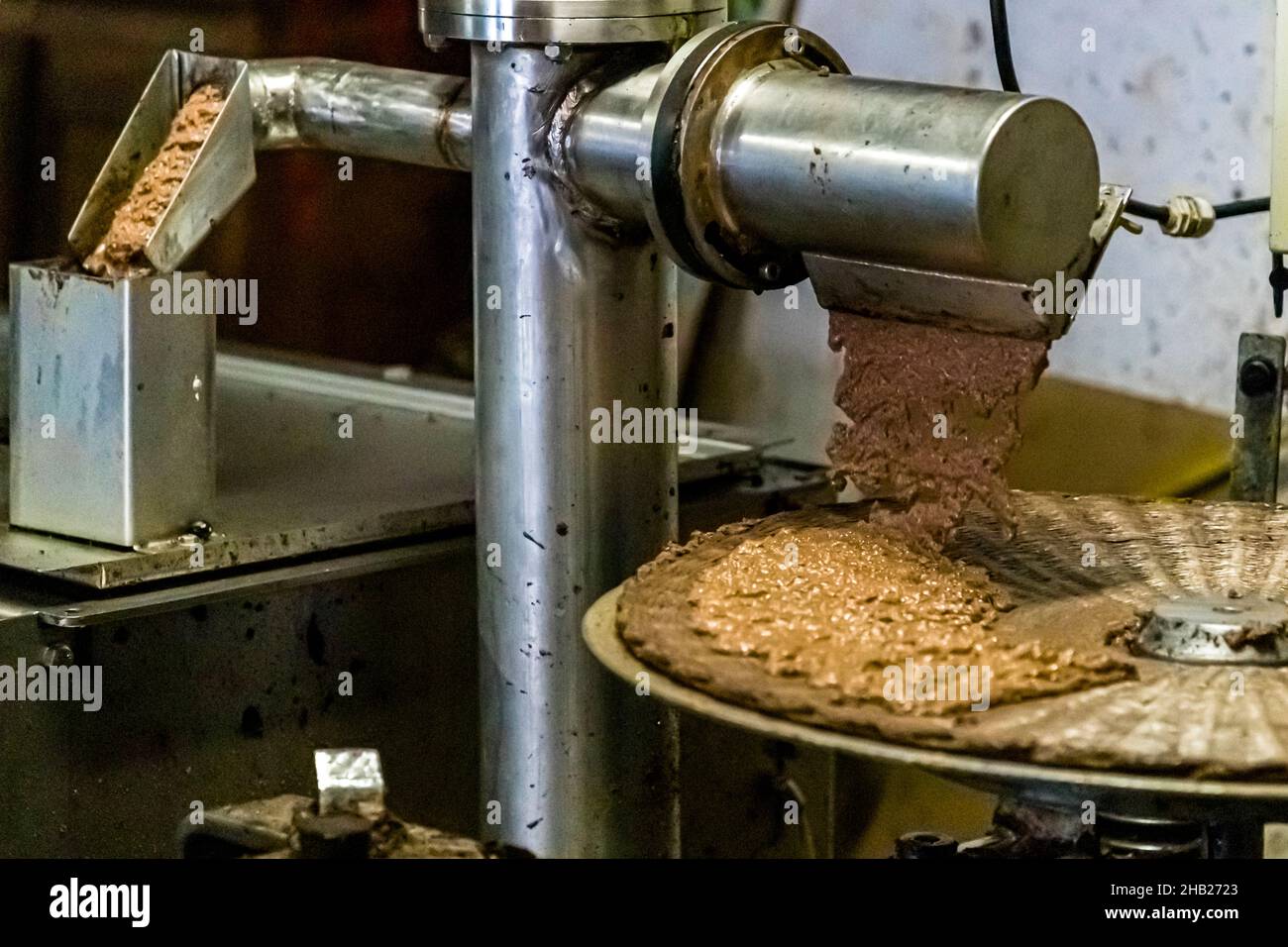 Traditional Oil Mill (Moulin a Huile Traditionnel) in Draguignan, France. After malaxation, the olive paste is applied to the press mats (scourtin) Stock Photo