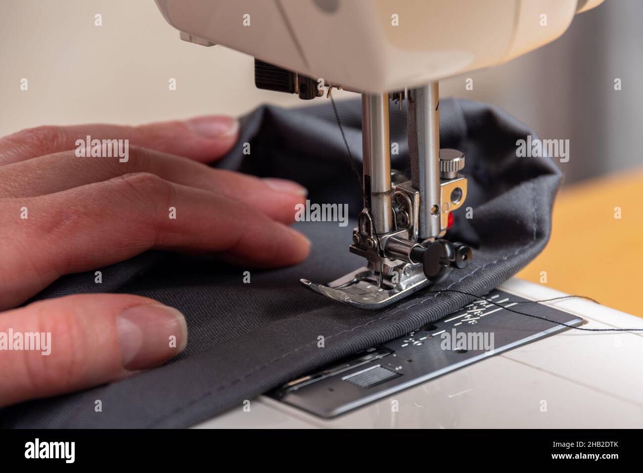 Sewing process. Closeup of repairing clothes, sewing on a sewing