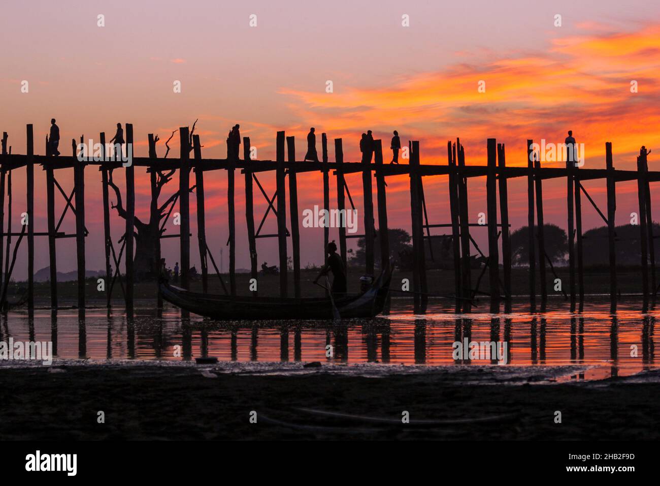Sunset at the U Bein Bridge at the Taungthaman Lake near Amarapura ...