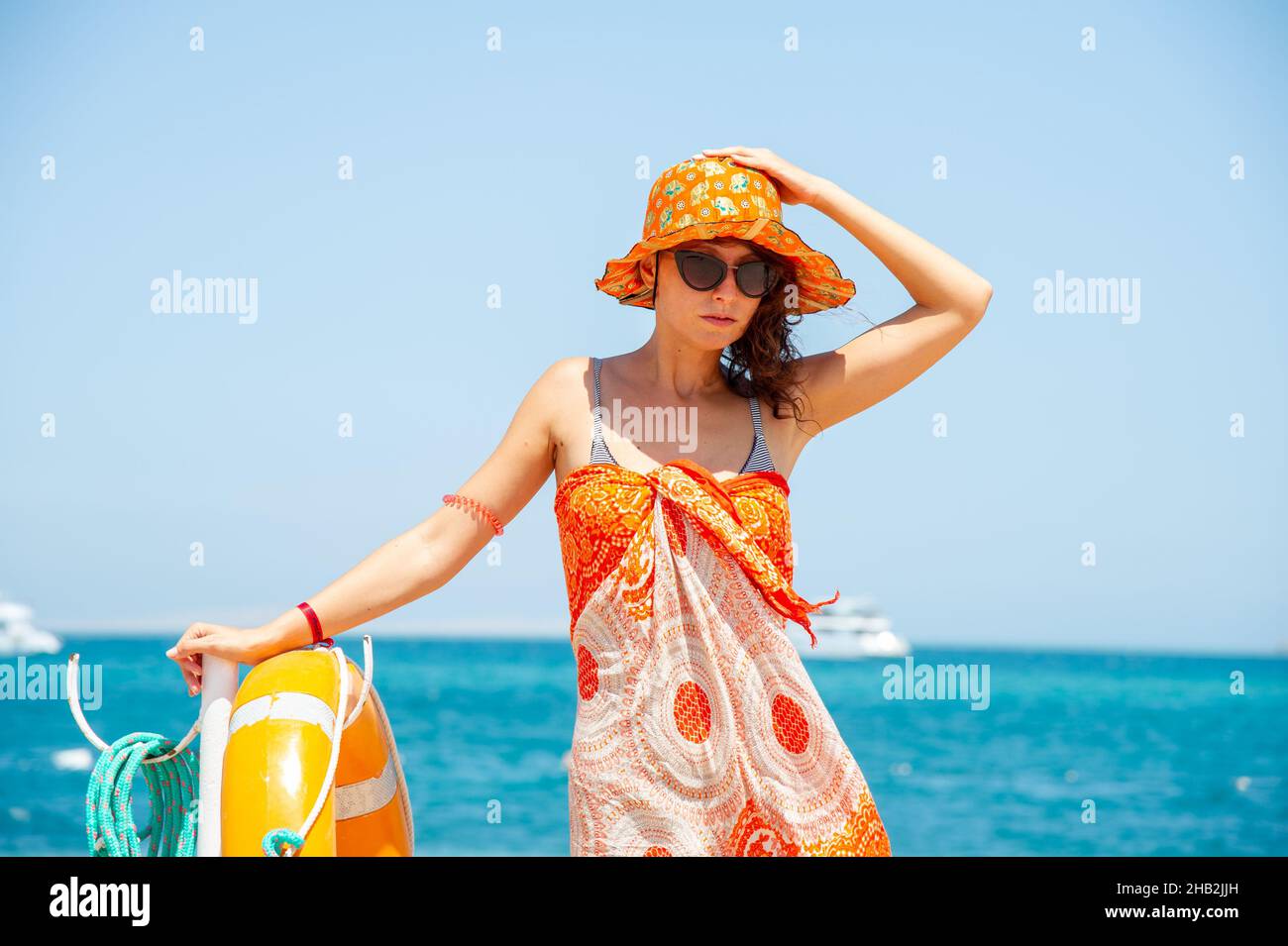Beautiful 40 years old woman posing on trip in Egypt Hurgada on the beach .Concept for trips Stock Photo