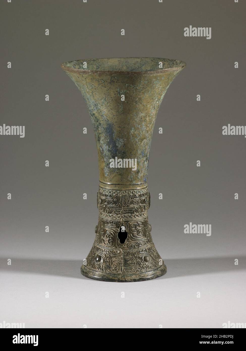 Wine Vessel (gu) with Design of Zoomorphic Masks and Spiral Patterns, Chinese, Shang dynasty, 1600–1050 BC, late 14th–early 13th century BC, Bronze, China, Asia, Containers, metalwork, height: 8 1/2 in. (21.6 cm Stock Photo