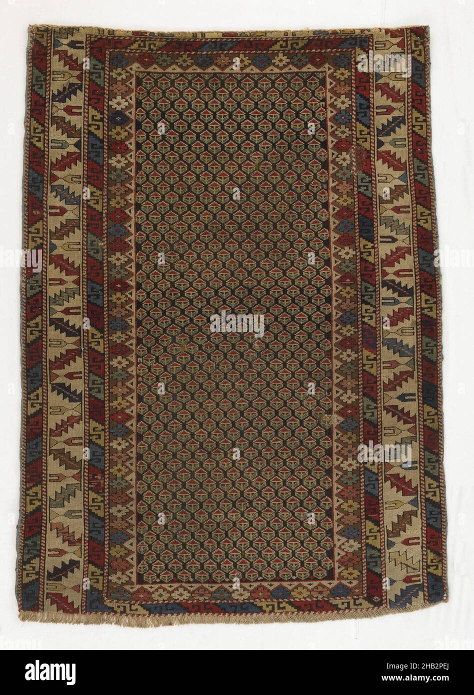Shirvan Carpet with Field of Staggered Rows of Small Motifs, Transcaucasian, late 19th century, Wool, Made in Caucasus, Azerbaijan, Asia, Coverings & hangings, textiles, 50 1/2 x 36 1/2 in. (128.3 x 92.7 cm Stock Photo
