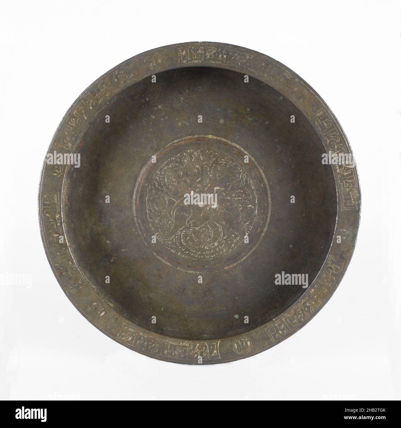 Dish with Design of Sphinx and Arabic Inscriptions, Persian, Seljuk period, 1038–1194, 12th century, Copper alloy, Made in Khorasan, Iran, Asia, Metalwork, 1 1/4 x 7 3/16 in. (3.2 x 18.3 cm Stock Photo