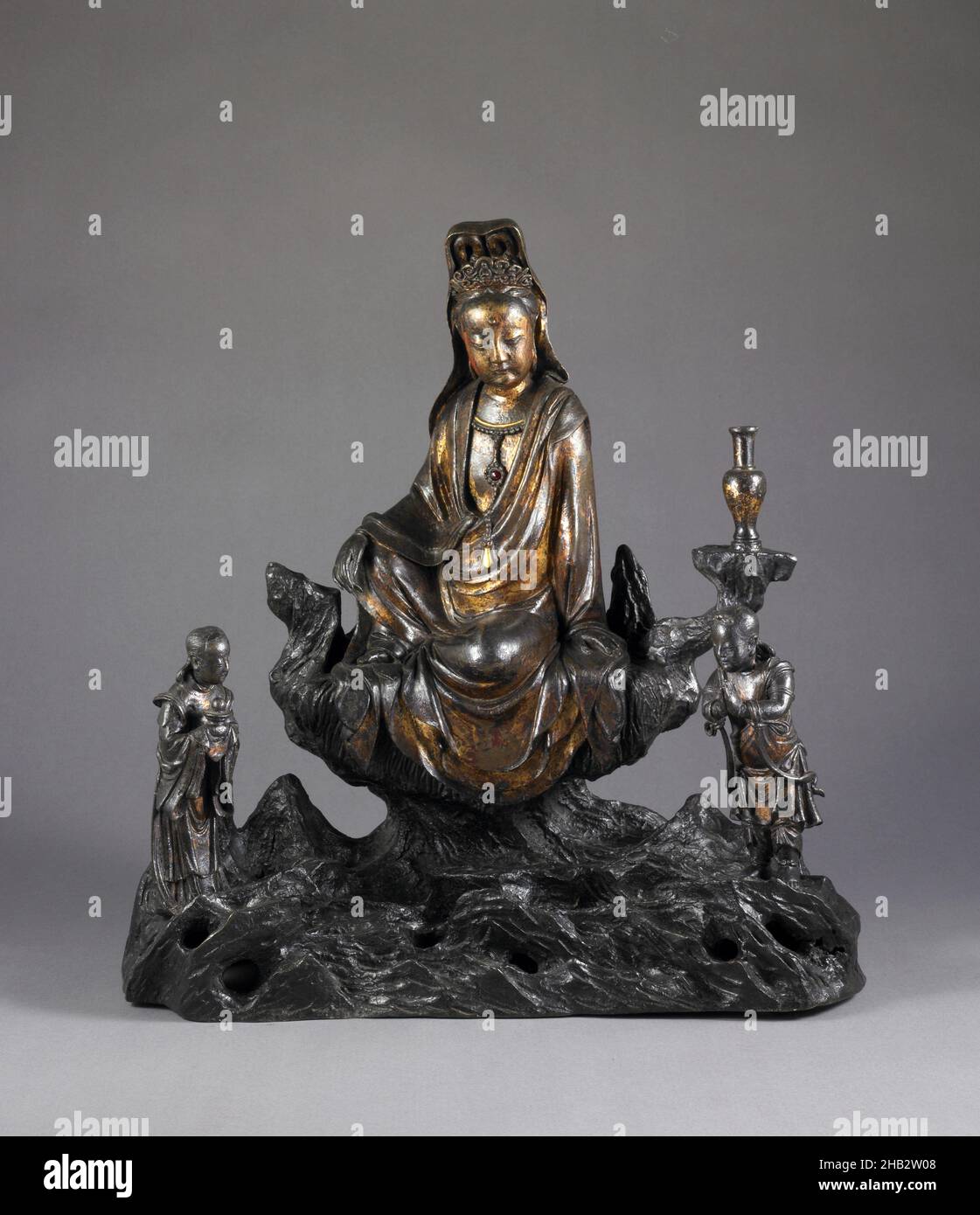 The Bodhisattva Avalokiteśvara with Acolytes Sudhanakumāra and Nāgakanyā at Mount Potalaka, Chinese, Ming dynasty, 1368–1644, Wanli period, 1573–1619, early 17th century, Bronze with jewel inlay and gilding, Made in China, Asia, Metalwork, sculpture, 17 x 16 7/8 x 9 in. (43.2 x 42.9 x 22.9 cm Stock Photo