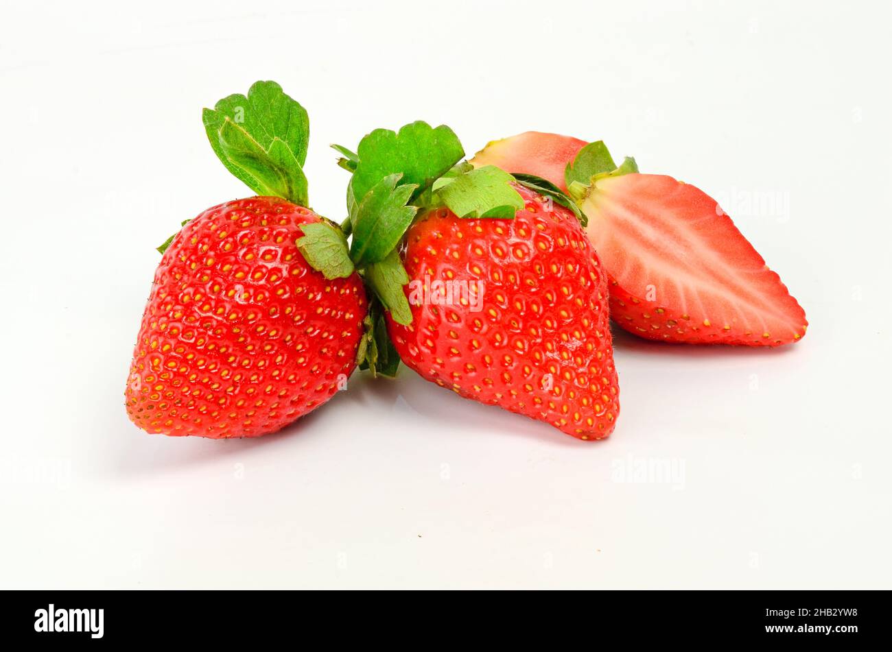 Three fresh strawberries isolated on white background Stock Photo - Alamy