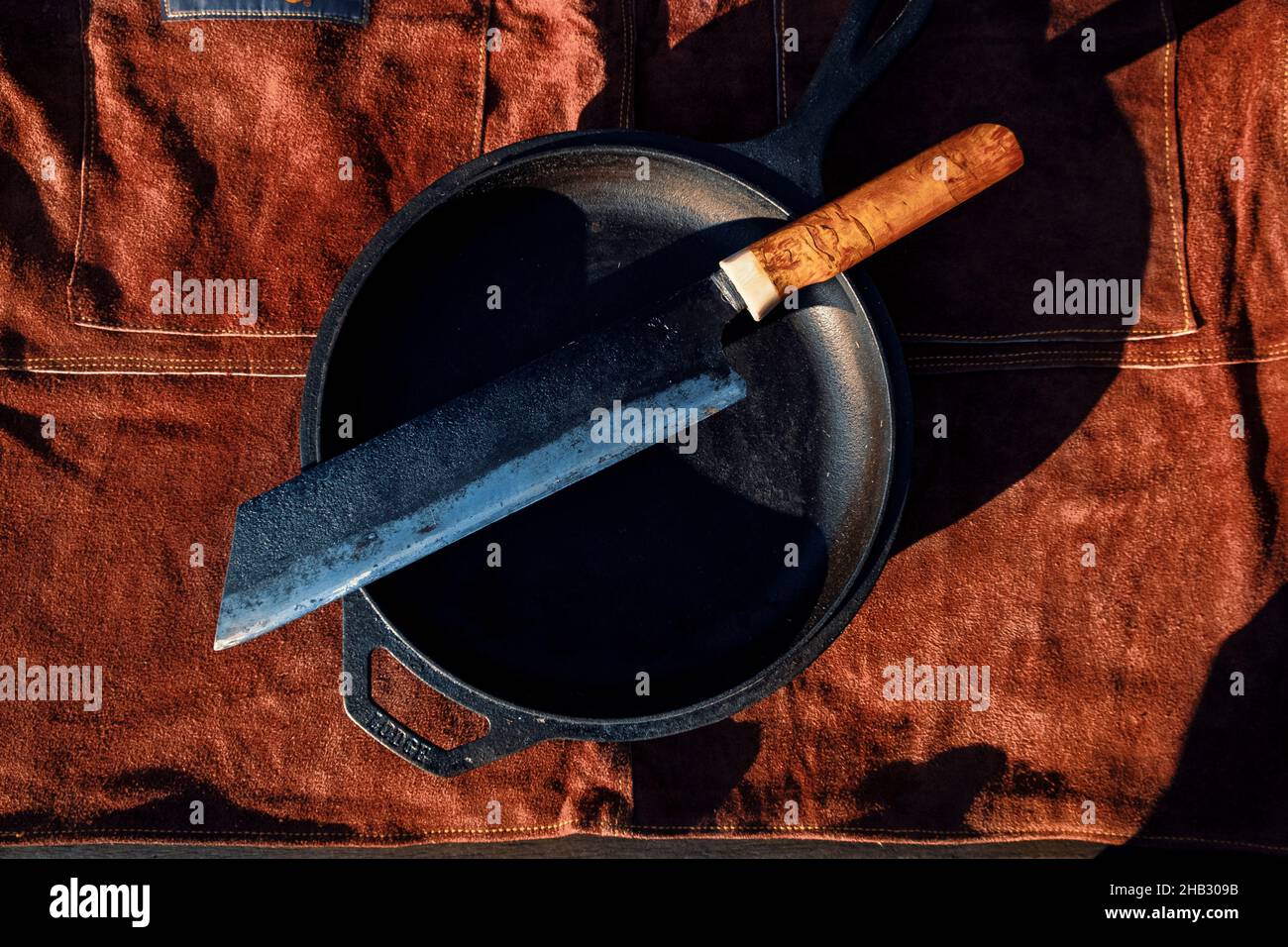 Still life of cast iron skillet and knife Stock Photo