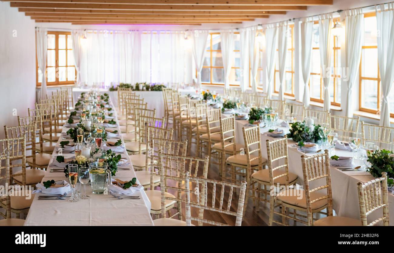 Tables with decoration and plates ready at wedding reception, shallow ...