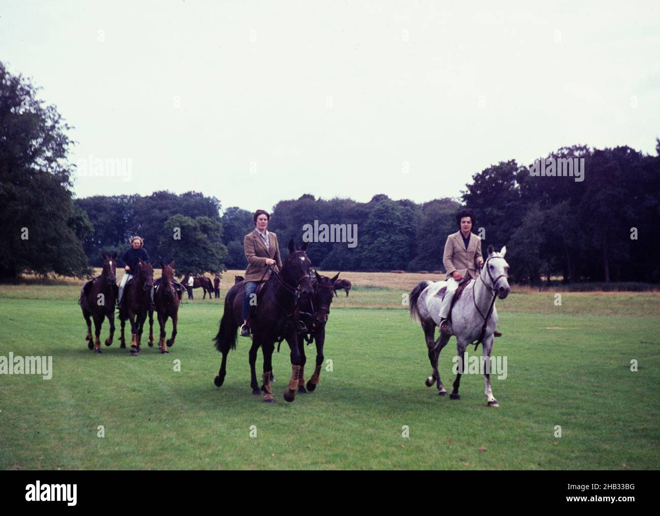 Women riding with spare horses at polo match Cirencester, Gloucestershire, England, UK 1967 Stock Photo