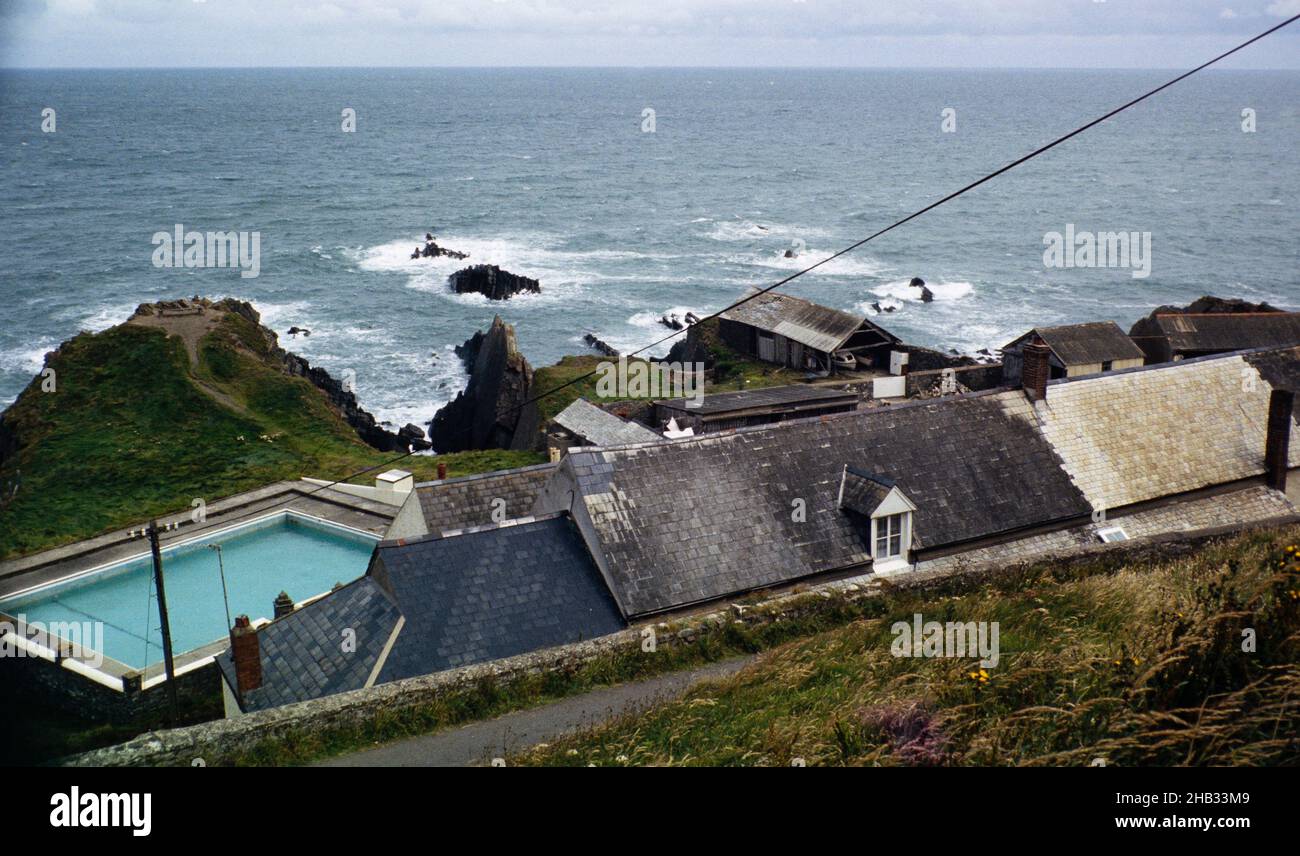 View out to Atlantic Ocean over hotel roof   which then had a swimming pool, Hartland Quay, north Devon coast, England, UK 1970s Stock Photo