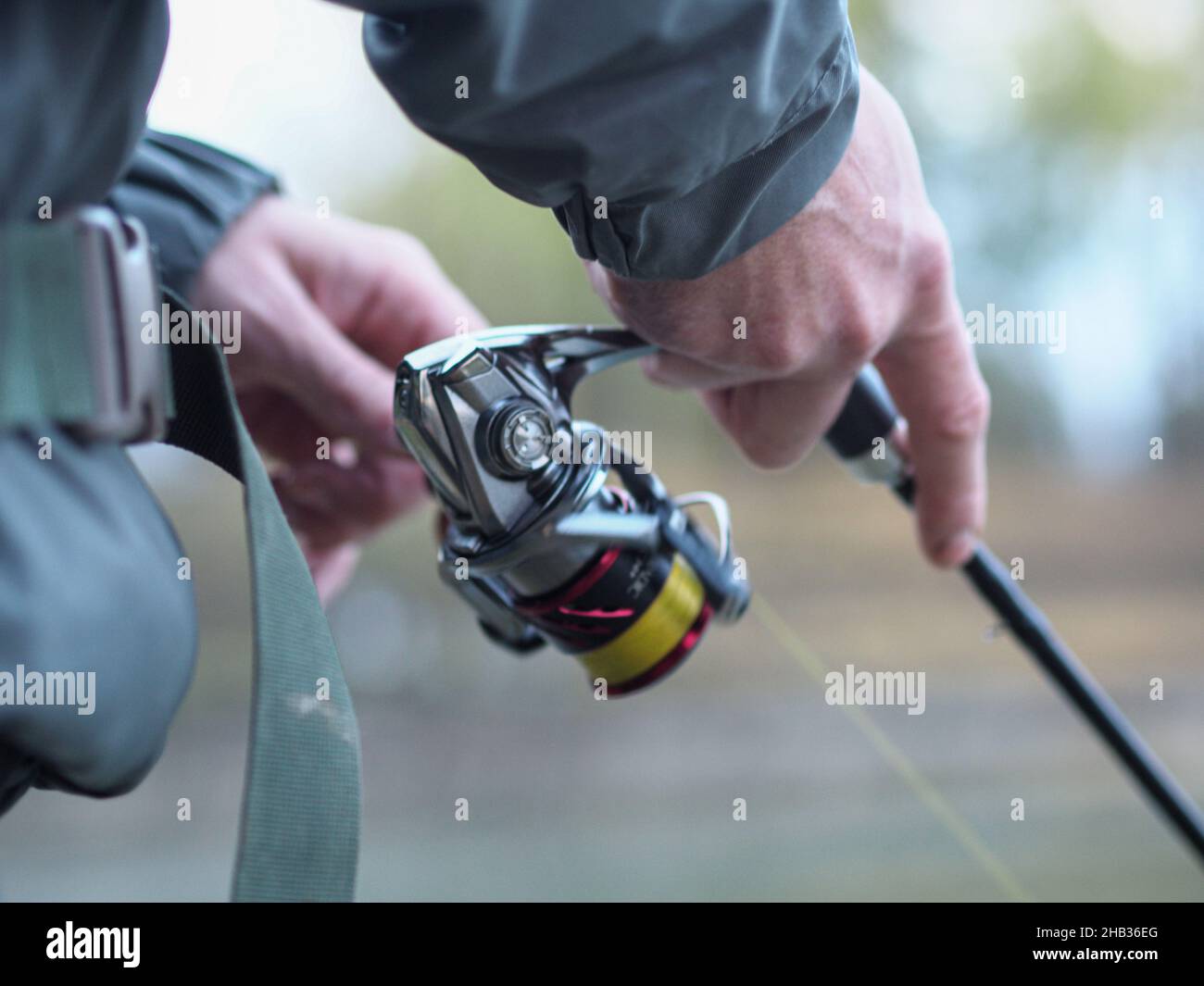 Hands of a man catching a fish with a fishing rod at the lake Stock ...