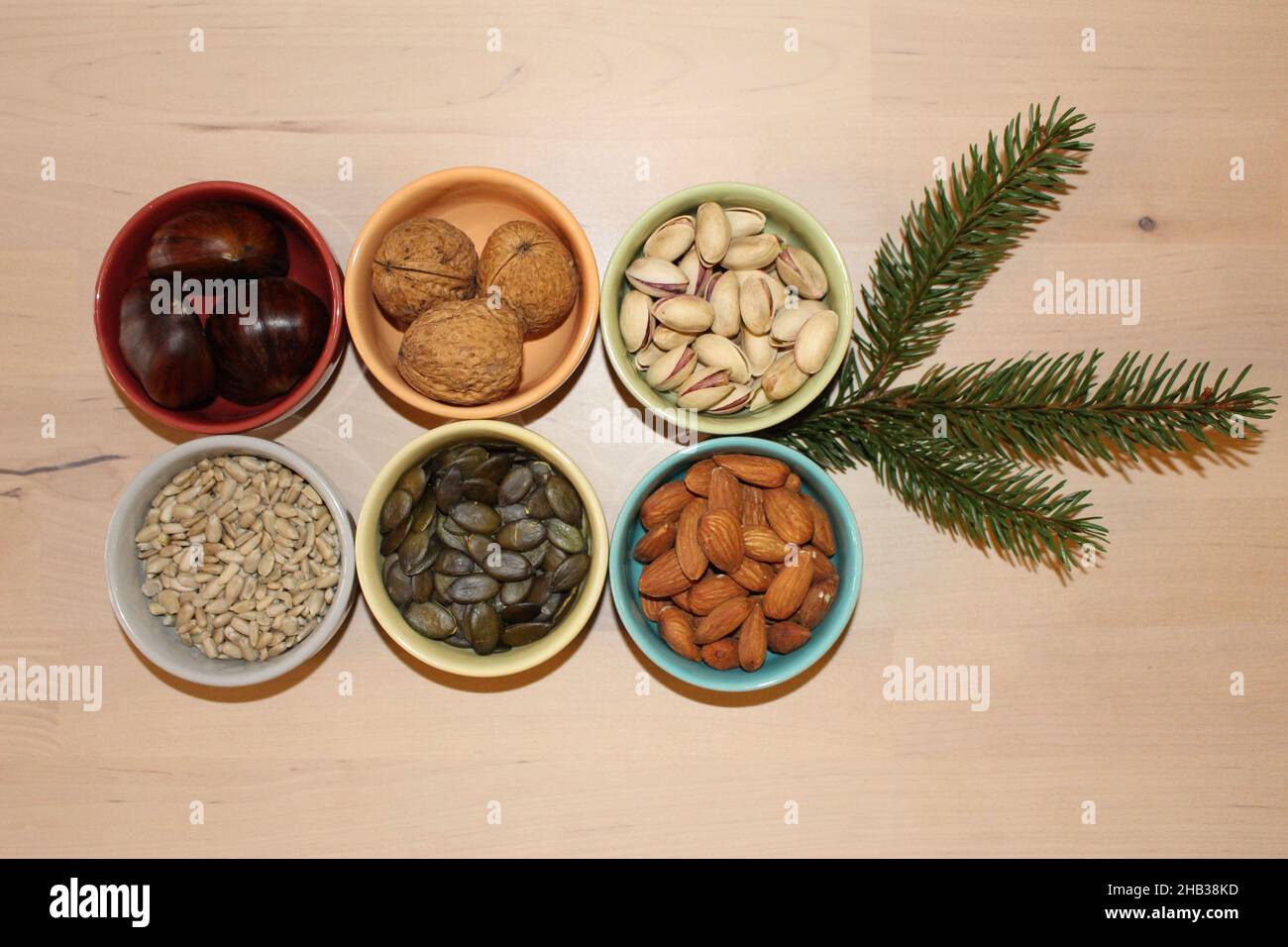 6 ceramic bowls containing whole nuts and seeds. Concept for health