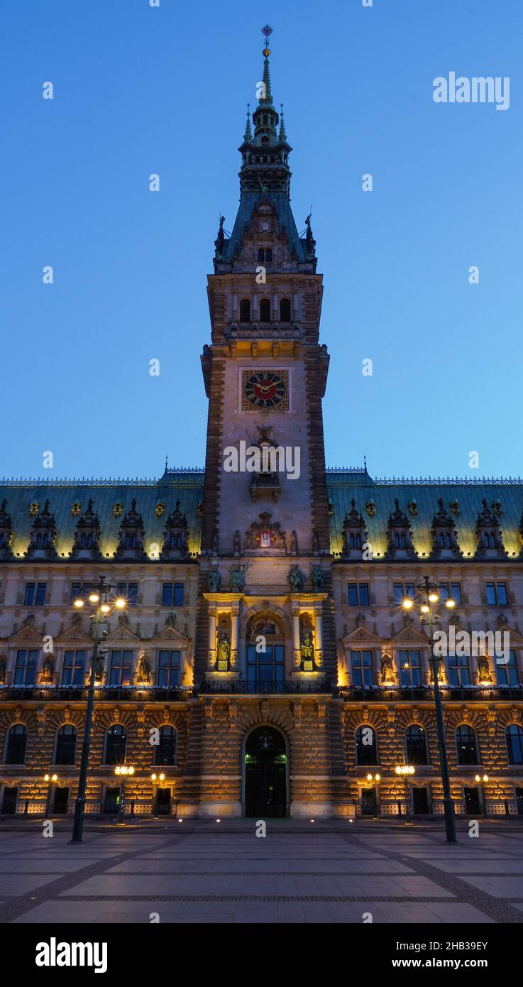 Twilight view of famous Hamburg city hall with Rathausmarkt square illuminated during blue hour Stock Photo