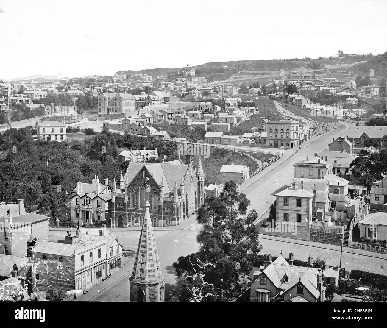 Dunedin, Burton Brothers studio, photography studio, 1870s, Dunedin, black-and-white photography, View from above looking along Stewart Street. Spire of the Church of England cathedral is visible in the foreground, church building in sight on street corner (at the site of the Fortune theatre Stock Photo
