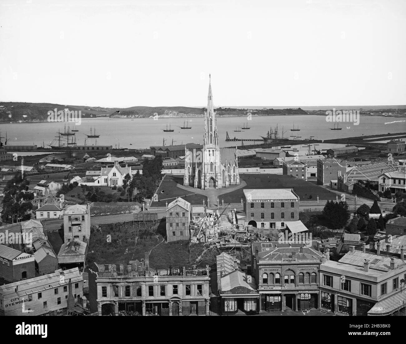 [Dunedin], Burton Brothers studio, photography studio, Dunedin, black-and-white photography, View looking at Moray Place - venue of the first (1st) church of Dunedin and out across the harbour. Shops and partially demolished house are in sight in the foreground Stock Photo
