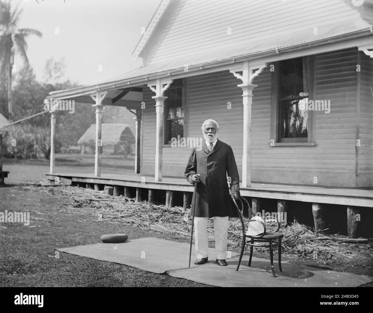 [King George of Tonga], Burton Brothers studio, photography studio, 26 July 1884, New Zealand, black-and-white photography, Semi-formal outdoor portrait of King George of Tonga, 86 years old, in front of the palace at Neiafu Stock Photo
