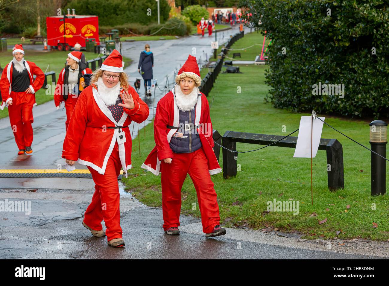 Women in a Santa Dash wave to the camera Stock Photo