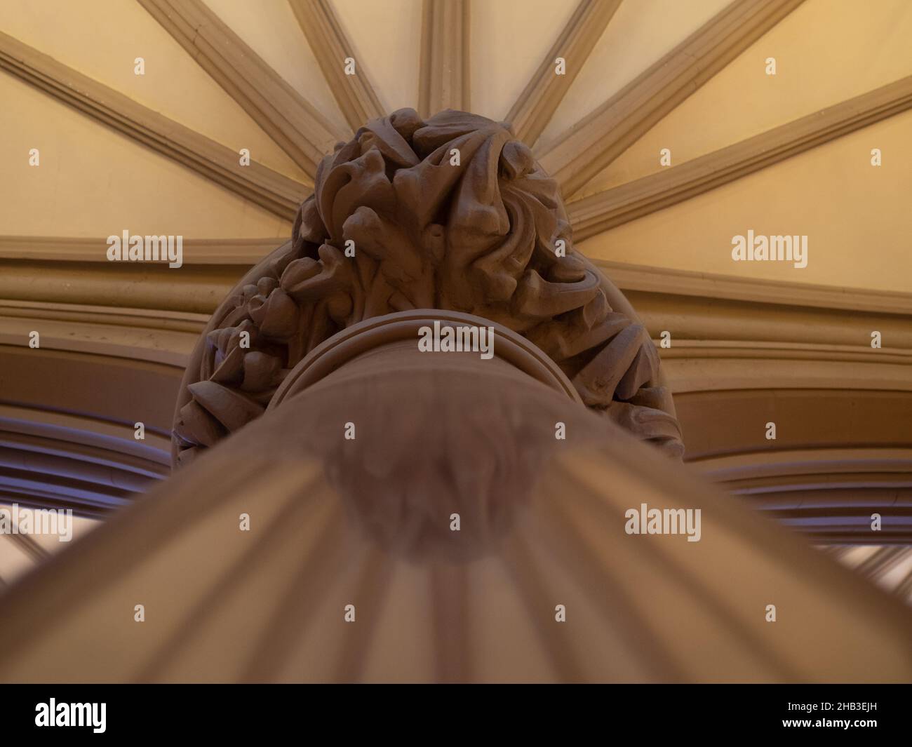 Low angle view of a marble column with a decorative top and ceiling molding in St. Francis Xavier College Church, a Gothic Revival Roman Catholic Chu Stock Photo