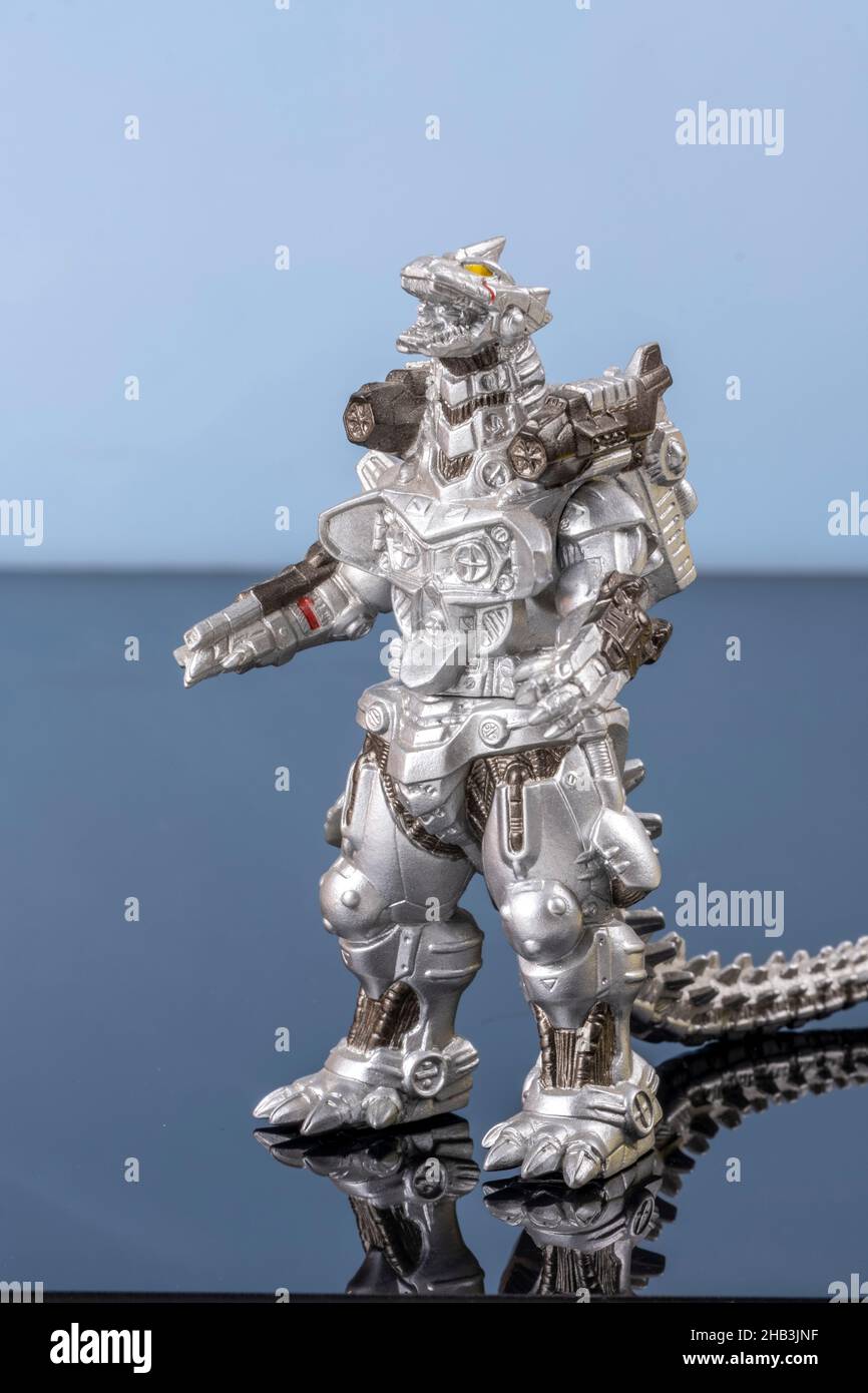 A silver metallic lizard toy. Legendary Asian monster. A giant figure mascot. Plastic creature in detail on reflecting surface. Cultural object Stock Photo