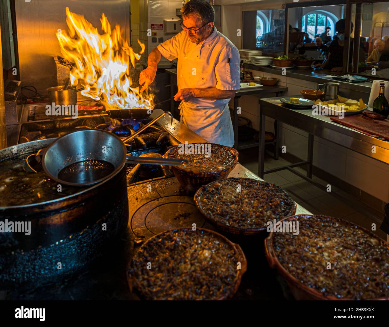 Chef Eric Rousselot prepares the famous Cassoulet Imperial at Hostellerie Etienne, a family-run business since 1956. Labastide d'Anjou, France. Heat and time are two important components for the delicious cassoulet from southern France Stock Photo